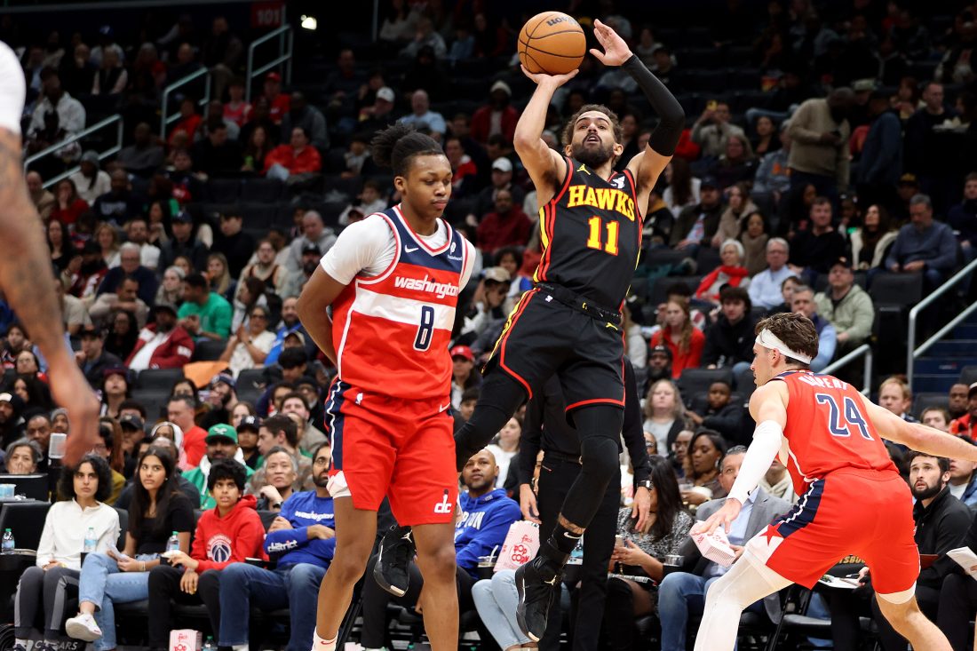 Feb 8, 2025; Washington, District of Columbia, USA; Atlanta Hawks guard Trae Young (11) shoots against Washington Wizards guard Bub Carrington (8) during the first half at Capital One Arena. Mandatory Credit: Daniel Kucin Jr.-Imagn Images