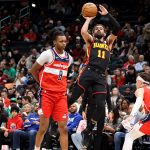 Feb 8, 2025; Washington, District of Columbia, USA; Atlanta Hawks guard Trae Young (11) shoots against Washington Wizards guard Bub Carrington (8) during the first half at Capital One Arena. Mandatory Credit: Daniel Kucin Jr.-Imagn Images