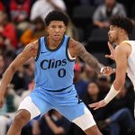 Feb 8, 2025; Inglewood, California, USA; Los Angeles Clippers forward MarJon Beauchamp (0) defends Utah Jazz guard Johnny Juzang (33) during the fourth quarter at Intuit Dome. Mandatory Credit: Kiyoshi Mio-Imagn Images