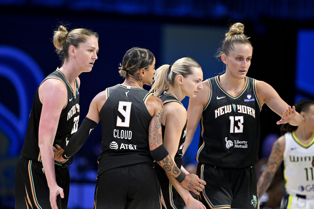 Aug 8, 2025; Arlington, Texas, USA; New York Liberty center Emma Meesseman (33) and guard Marine Johannes (23) and guard Natasha Cloud (9) and forward Leonie Fiebich (13) gather in a huddle during the second half against the Dallas Wings at College Park Center. Mandatory Credit: Jerome Miron-Imagn Images