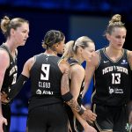 Aug 8, 2025; Arlington, Texas, USA; New York Liberty center Emma Meesseman (33) and guard Marine Johannes (23) and guard Natasha Cloud (9) and forward Leonie Fiebich (13) gather in a huddle during the second half against the Dallas Wings at College Park Center. Mandatory Credit: Jerome Miron-Imagn Images