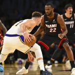 Nov 2, 2025; Los Angeles, California, USA; Los Angeles Lakers guard Luka Dončić (77) moves the ball against Miami Heat forward Andrew Wiggins (22) during the first half at Crypto.com Arena. Mandatory Credit: Jonathan Hui-Imagn Images