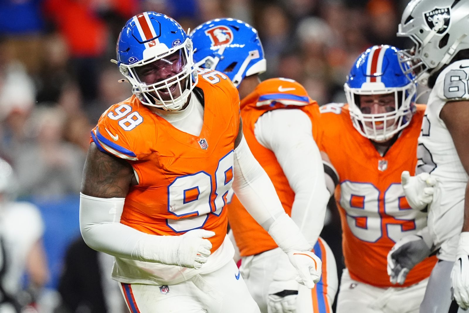 Nov 6, 2025; Denver, Colorado, USA; Denver Broncos defensive end John Franklin-Myers (98) reacts against the Las Vegas Raiders during the first half at Empower Field at Mile High. Mandatory Credit: Ron Chenoy-Imagn Images