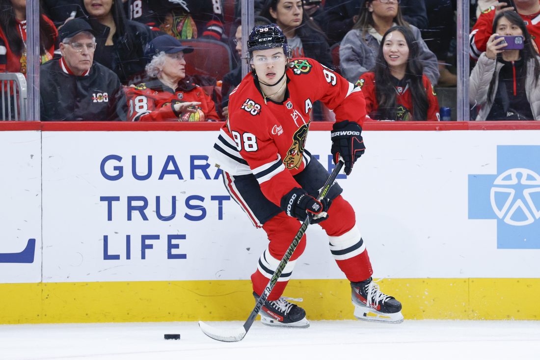 Nov 18, 2025; Chicago, Illinois, USA; Chicago Blackhawks center Connor Bedard (98) looks to pass the puck against the Calgary Flames during the first period at United Center. Mandatory Credit: Kamil Krzaczynski-Imagn Images