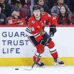 Nov 18, 2025; Chicago, Illinois, USA; Chicago Blackhawks center Connor Bedard (98) looks to pass the puck against the Calgary Flames during the first period at United Center. Mandatory Credit: Kamil Krzaczynski-Imagn Images