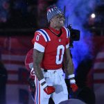 Dec 1, 2025; Foxborough, Massachusetts, USA; New England Patriots cornerback Christian Gonzalez (0) runs onto the field prior to the game against the New York Giants at Gillette Stadium. Mandatory Credit: Eric Canha-Imagn Images