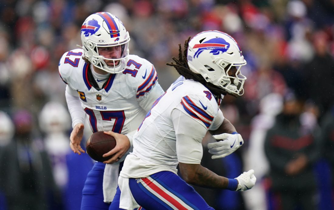 Dec 14, 2025; Foxborough, Massachusetts, USA; Buffalo Bills quarterback Josh Allen (17) fakes the hand off to running back James Cook III (4) against the New England Patriots in the second half at Gillette Stadium. Mandatory Credit: David Butler II-Imagn Images