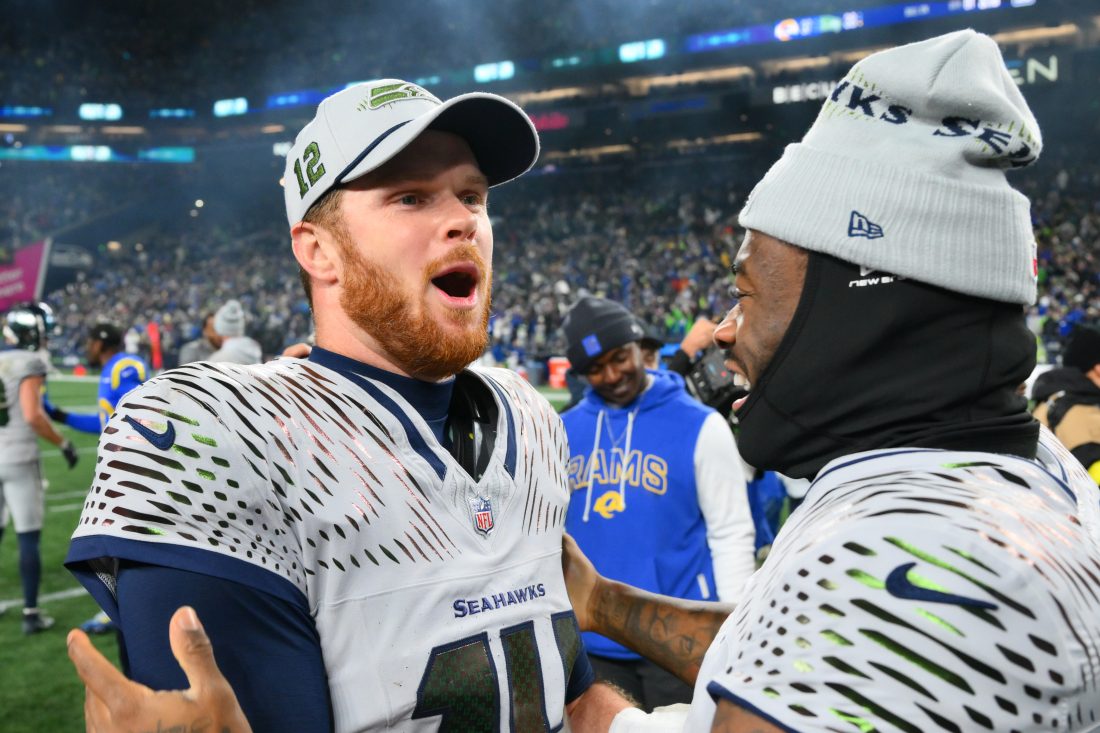 Dec 18, 2025; Seattle, Washington, USA; Seattle Seahawks quarterback Sam Darnold (14) and quarterback Jalen Milroe (6) celebrate after defeating the Los Angeles Rams in overtime at Lumen Field. Mandatory Credit: Steven Bisig-Imagn Images