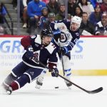 Dec 19, 2025; Denver, Colorado, USA; Winnipeg Jets center Jonathan Toews (19) shoot the puck past Colorado Avalanche defenseman Samuel Girard (49) in the first period at Ball Arena. Mandatory Credit: Ron Chenoy-Imagn Images