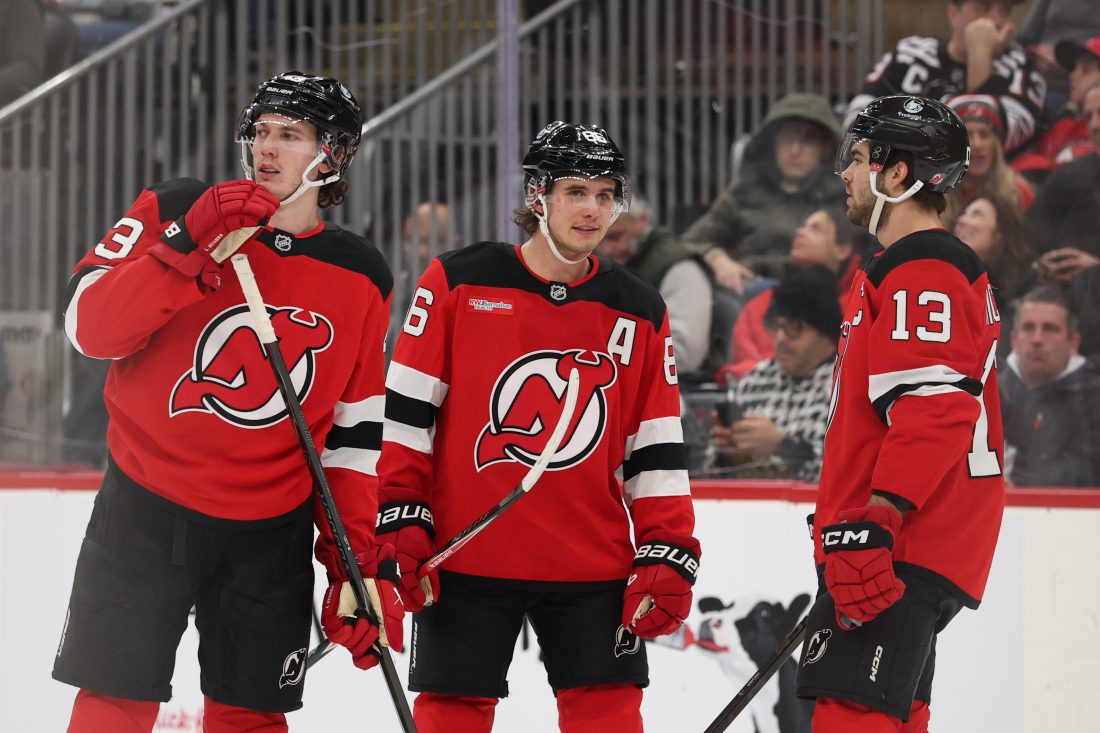 Jan 3, 2026; Newark, New Jersey, USA; New Jersey Devils defenseman Luke Hughes (43), center Jack Hughes (86) and center Nico Hischier (13) talk during the second period of their game against the Utah Mammoth at Prudential Center. Mandatory Credit: Ed Mulholland-Imagn Images