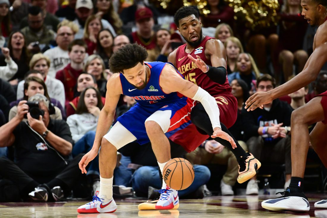 Jan 4, 2026; Cleveland, Ohio, USA; Cleveland Cavaliers guard Donovan Mitchell (45) defends Detroit Pistons guard Cade Cunningham (2) during the second half at Rocket Arena. Mandatory Credit: Ken Blaze-Imagn Images