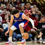 Jan 4, 2026; Cleveland, Ohio, USA; Cleveland Cavaliers guard Donovan Mitchell (45) defends Detroit Pistons guard Cade Cunningham (2) during the second half at Rocket Arena. Mandatory Credit: Ken Blaze-Imagn Images