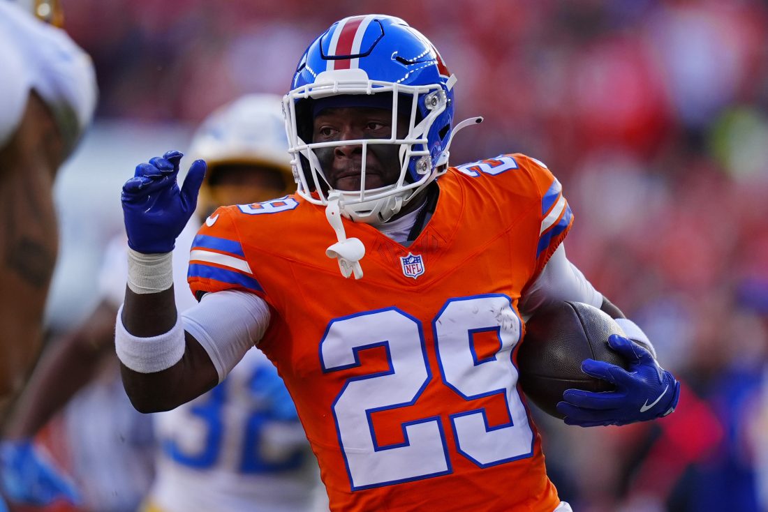 Jan 4, 2026; Denver, Colorado, USA; Denver Broncos cornerback Ja'quan McMillian (29) runs with the ball during the first half against the Los Angeles Chargers at Empower Field at Mile High. Mandatory Credit: Ron Chenoy-Imagn Images