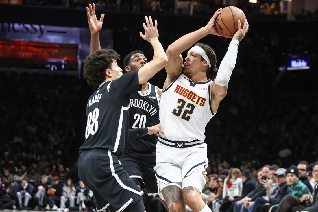 Jan 4, 2026; Brooklyn, New York, USA; Denver Nuggets forward Aaron Gordon (32) is double teammed by Brooklyn Nets guard Nolan Traore (88) and center Day'ron Sharpe (20) in the first quarter at Barclays Center. Mandatory Credit: Wendell Cruz-Imagn Images