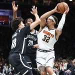 Jan 4, 2026; Brooklyn, New York, USA; Denver Nuggets forward Aaron Gordon (32) is double teammed by Brooklyn Nets guard Nolan Traore (88) and center Day'ron Sharpe (20) in the first quarter at Barclays Center. Mandatory Credit: Wendell Cruz-Imagn Images