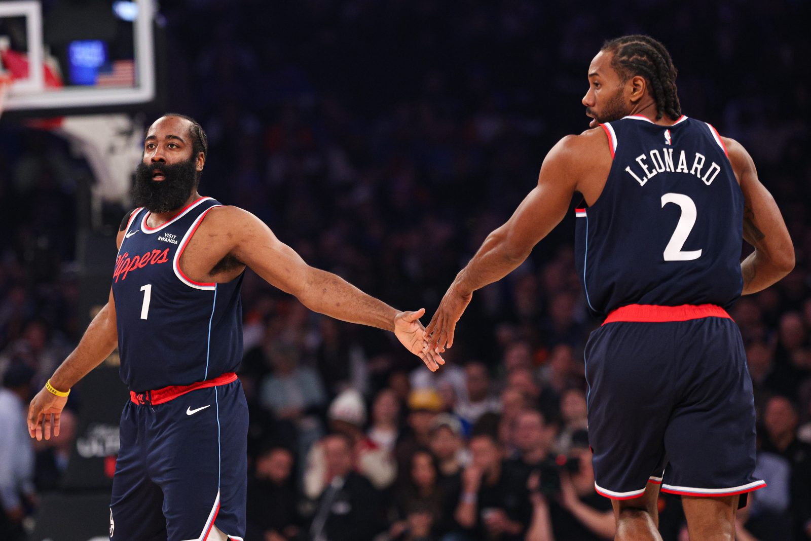 Jan 7, 2026; New York, New York, USA; LA Clippers guard James Harden (1) slaps hands with forward Kawhi Leonard (2) during the first quarter against the New York Knicks at Madison Square Garden. Mandatory Credit: Vincent Carchietta-Imagn Images