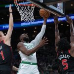 Jan 9, 2026; Boston, Massachusetts, USA; Boston Celtics guard Jaylen Brown (7) drives to the basket against Toronto Raptors guard Immanuel Quickley (5) and guard Gradey Dick (1) in the first quarter at TD Garden. Mandatory Credit: David Butler II-Imagn Images