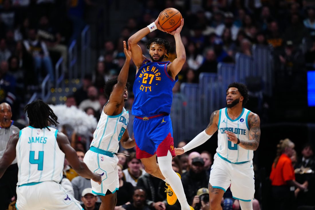 Jan 18, 2026; Denver, Colorado, USA; Charlotte Hornets guard Collin Sexton (8) defends Denver Nuggets guard Jamal Murray (27)in the second quarter at Ball Arena.
