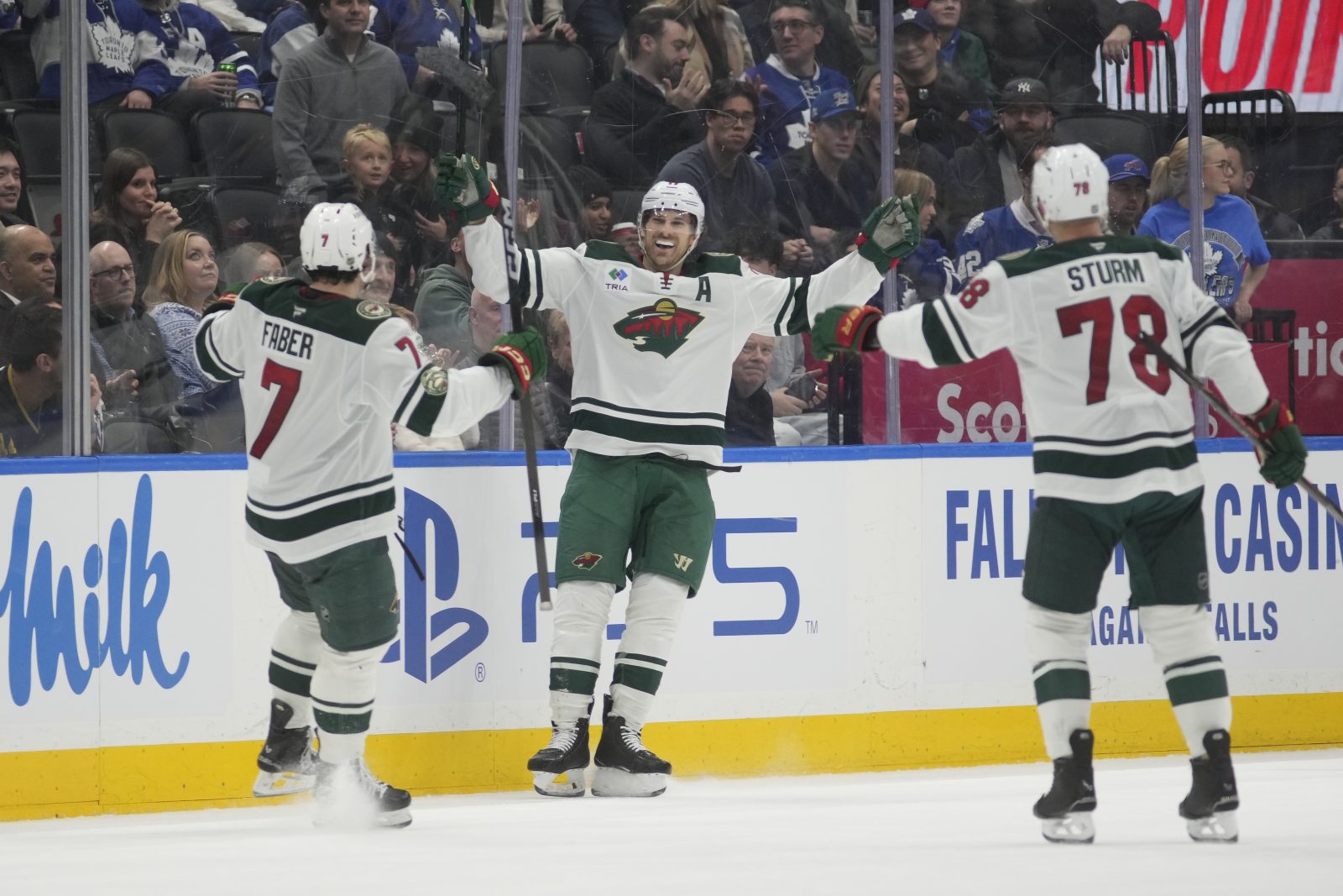 Jan 19, 2026; Toronto, Ontario, CAN; Minnesota Wild forward Marcus Foligno (17) (center) celebrates with defenseman Brock Faber (7) and forward Nico Sturm (78) after scoring his third goal of the game against the Toronto Maple Leafs during the third period at Scotiabank Arena. Mandatory Credit: John E. Sokolowski-Imagn Images