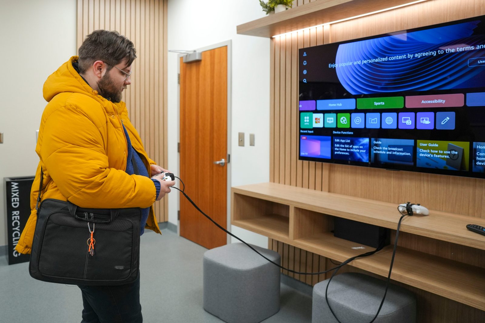News Sentinel reporter Keenan Thomas plays with the Xbox controller attached to a LG TV at the new Laundry Lounge powered by LG inside the Fred Brown Hall at the University of Tennessee of campus on Jan. 20, 2026.