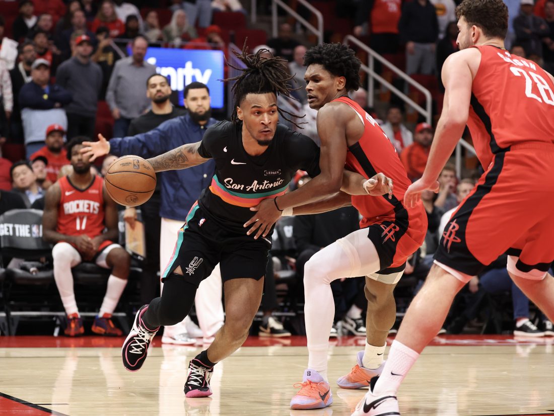 Jan 20, 2026; Houston, Texas, USA;San Antonio Spurs guard Stephon Castle (5) dribbles against Houston Rockets guard Amen Thompson (1) in the second half at Toyota Center. Mandatory Credit: Thomas Shea-Imagn Images