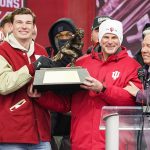 Indiana Hoosiers quarterback Fernando Mendoza (15) holds the Heisman Trophy with Indiana Hoosiers head coach Curt Cignetti on Saturday, Jan. 24, 2026, during the Indiana Football College Football Playoff National Championship celebration and parade at Memorial Stadium in Bloomington.