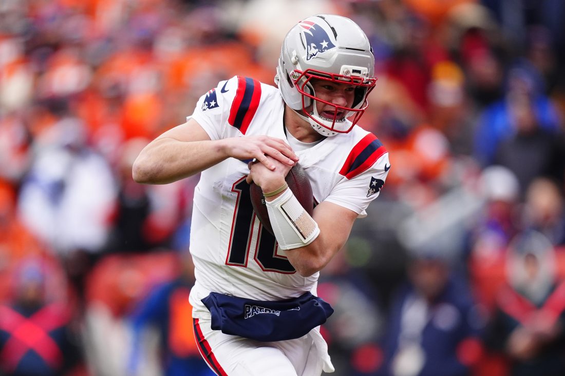 Jan 25, 2026; Denver, CO, USA; New England Patriots quarterback Drake Maye (10) rushes the ball for a touchdown against the Denver Broncos during the first half in the 2026 AFC Championship Game at Empower Field at Mile High. Mandatory Credit: Ron Chenoy-Imagn Images