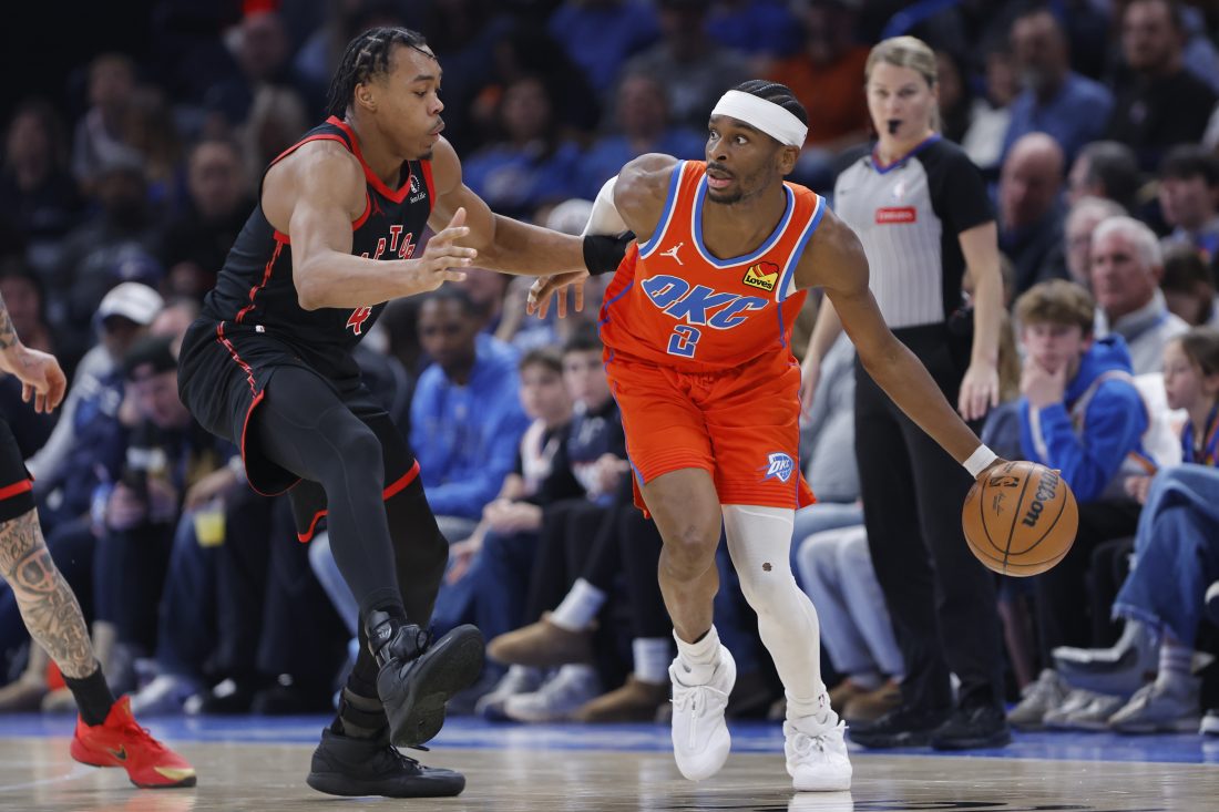 Jan 25, 2026; Oklahoma City, Oklahoma, USA; Oklahoma City Thunder guard Shai Gilgeous-Alexander (2) moves the ball around Toronto Raptors forward/guard Scottie Barnes (4) during the second half at Paycom Center. Mandatory Credit: Alonzo Adams-Imagn Images