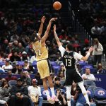 Jan 29, 2026; Washington, District of Columbia, USA; Washington Wizards guard Tre Johnson (12) takes a shot over Milwaukee Bucks guard Ryan Rollins (13) during the first half at Capital One Arena. Mandatory Credit: Daniel Kucin Jr.-Imagn Images