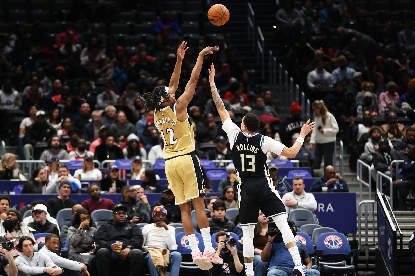Jan 29, 2026; Washington, District of Columbia, USA; Washington Wizards guard Tre Johnson (12) takes a shot over Milwaukee Bucks guard Ryan Rollins (13) during the first half at Capital One Arena. Mandatory Credit: Daniel Kucin Jr.-Imagn Images