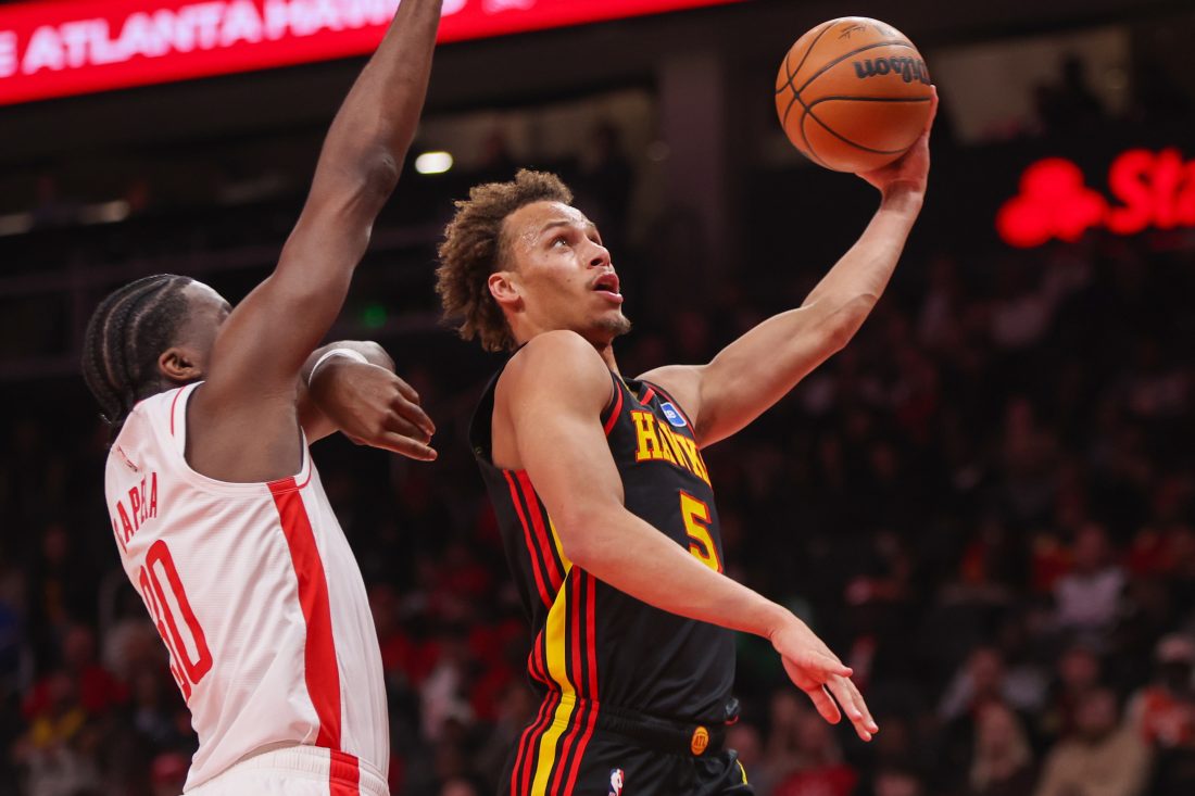 Jan 29, 2026; Atlanta, Georgia, USA; Atlanta Hawks guard Dyson Daniels (5) shoots past Houston Rockets center Clint Capela (30) in the first quarter at State Farm Arena.