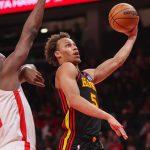 Jan 29, 2026; Atlanta, Georgia, USA; Atlanta Hawks guard Dyson Daniels (5) shoots past Houston Rockets center Clint Capela (30) in the first quarter at State Farm Arena.