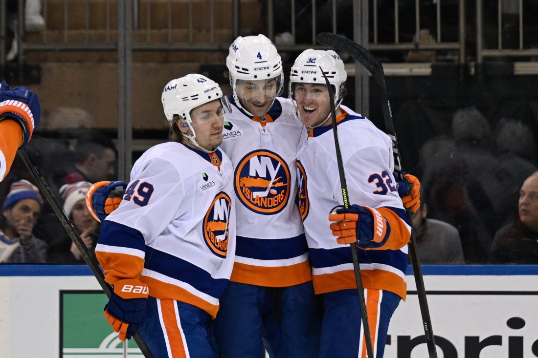 Jan 29, 2026; New York, New York, USA; New York Islanders right wing Max Shabanov (49) and New York Islanders center Kyle MacLean (32) celebrates the goal by New York Islanders defenseman Carson Soucy (4) against the New York Rangers during the second period at Madison Square Garden.