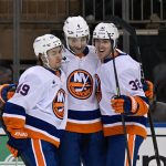 Jan 29, 2026; New York, New York, USA; New York Islanders right wing Max Shabanov (49) and New York Islanders center Kyle MacLean (32) celebrates the goal by New York Islanders defenseman Carson Soucy (4) against the New York Rangers during the second period at Madison Square Garden.