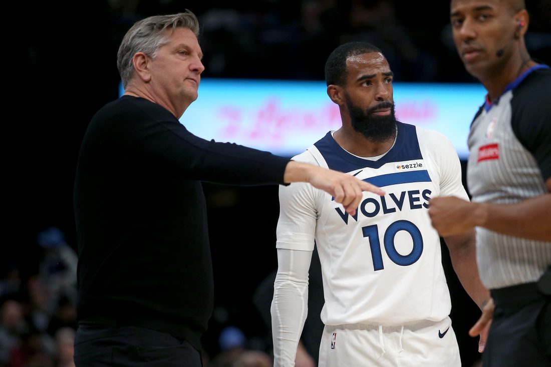 Jan 31, 2026; Memphis, Tennessee, USA; Minnesota Timberwolves head coach Chris Finch (left) talks with guard Mike Conley (10) during the third quarter against the Memphis Grizzlies at FedExForum. Mandatory Credit: Petre Thomas-Imagn Images