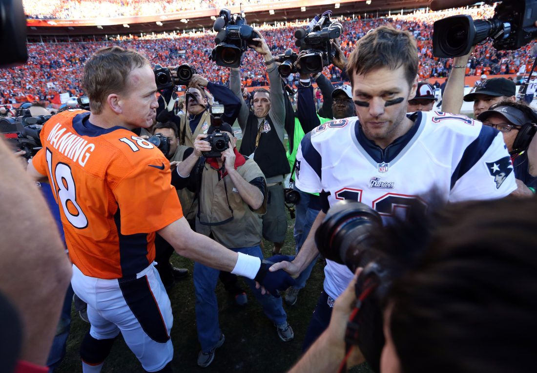 Jan 19, 2014; Denver, CO, USA; Denver Broncos quarterback Peyton Manning (18) and New England Patriots quarterback Tom Brady (12) shake hands after the 2013 AFC championship playoff football game at Sports Authority Field at Mile High. Mandatory Credit: Matthew Emmons-USA TODAY Sports
