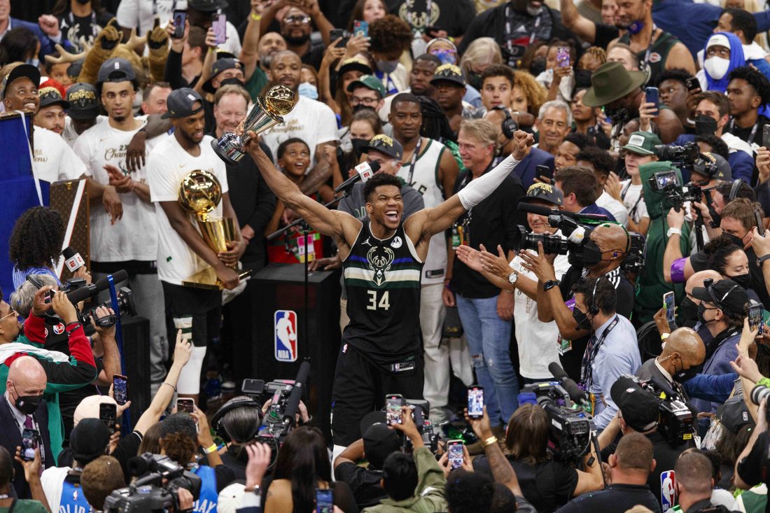 Jul 20, 2021; Milwaukee, Wisconsin, USA; Milwaukee Bucks forward Giannis Antetokounmpo (34) celebrates with the NBA Finals MVP Trophy following the game against the Phoenix Suns following game six of the 2021 NBA Finals at Fiserv Forum. Mandatory Credit: Jeff Hanisch-USA TODAY Sports