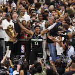 Jul 20, 2021; Milwaukee, Wisconsin, USA; Milwaukee Bucks forward Giannis Antetokounmpo (34) celebrates with the NBA Finals MVP Trophy following the game against the Phoenix Suns following game six of the 2021 NBA Finals at Fiserv Forum. Mandatory Credit: Jeff Hanisch-USA TODAY Sports