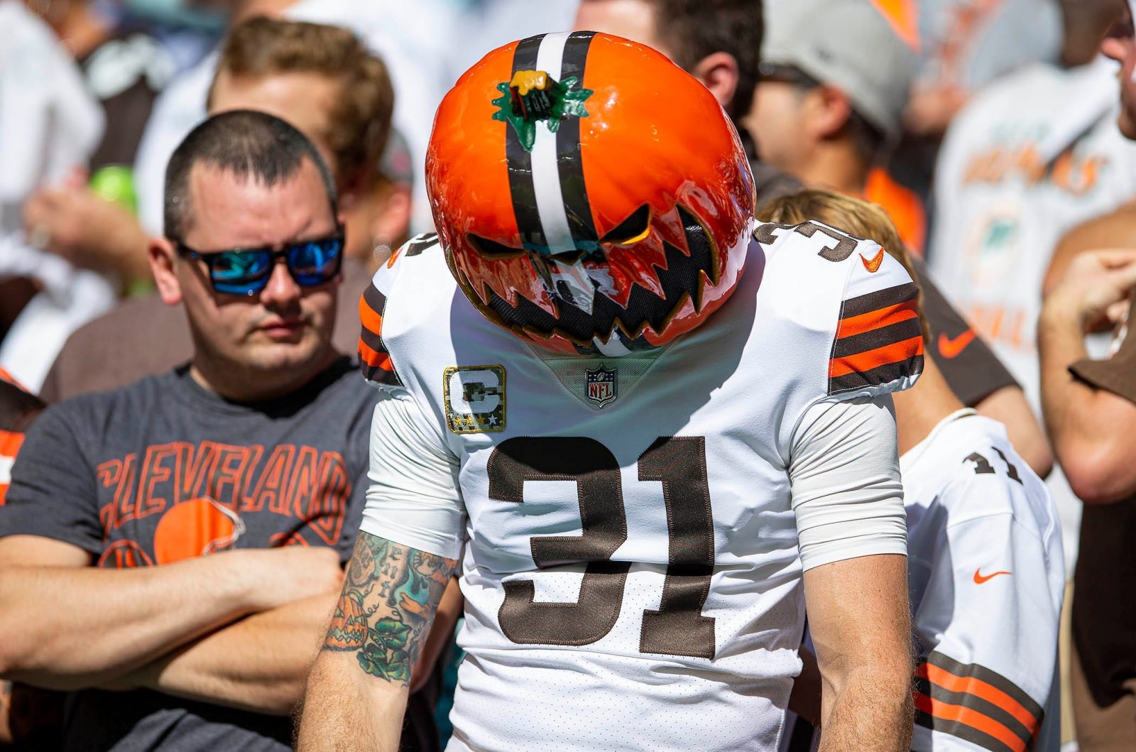 A sad Cleveland Browns fan wearing a pumpkin in the stands during game against Miami Dolphins during NFL action Sunday November 13, 2022 at Hard Rock Stadium in Miami Gardens.