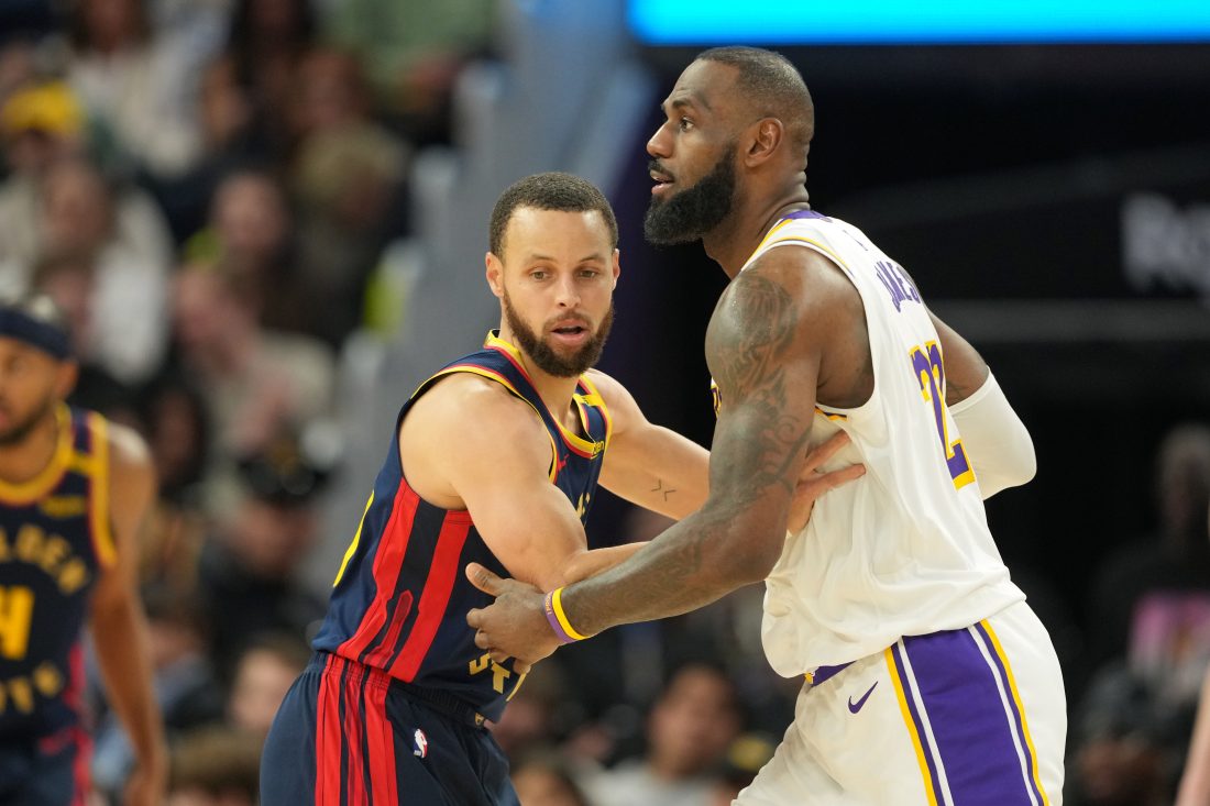 Jan 25, 2025; San Francisco, California, USA; Golden State Warriors guard Stephen Curry (left) defends against Los Angeles Lakers forward LeBron James (right) during the fourth quarter at Chase Center. Mandatory Credit: Darren Yamashita-Imagn Images