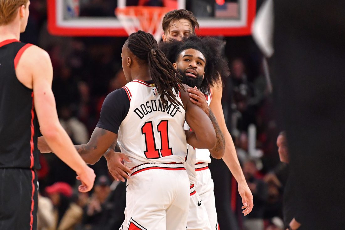 Feb 28, 2025; Chicago, Illinois, USA; Chicago Bulls guard Coby White (behind) hugs guard Ayo Dosunmu (11) during overtime against the Toronto Raptors at the United Center. Mandatory Credit: Patrick Gorski-Imagn Images