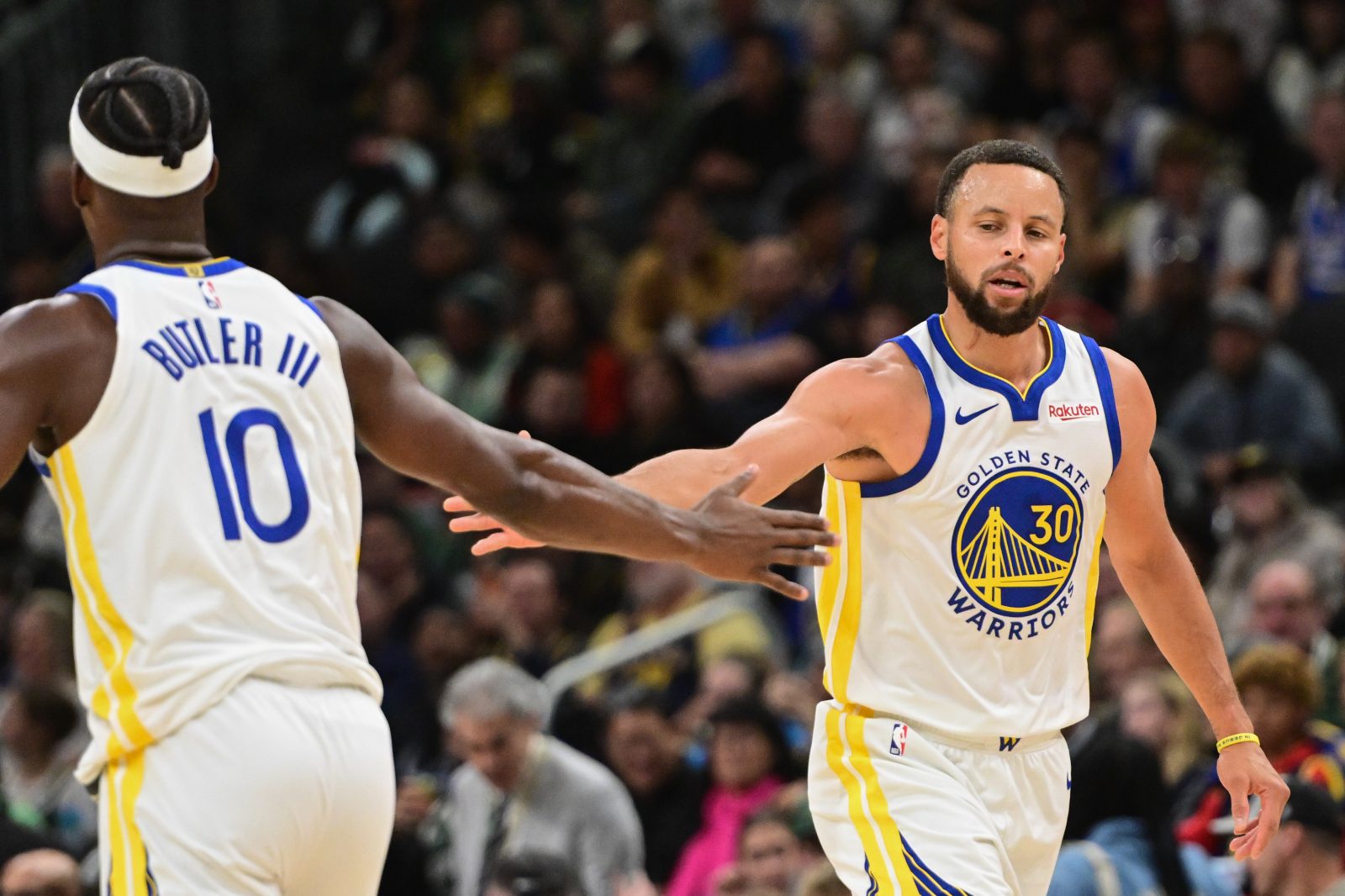 Oct 30, 2025; Milwaukee, Wisconsin, USA; Golden State Warriors guard Stephen Curry (30) reacts with forward Jimmy Butler (10) after scoring a basket in the 3rd quarter against the Milwaukee Bucks at Fiserv Forum. Mandatory Credit: