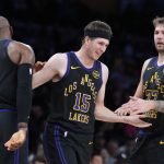 Nov 18, 2025; Los Angeles, California, USA; Los Angeles Lakers guard Austin Reaves (15) is congratulated by forward LeBron James (23) and guard Luka Doncic (77) after a three-point basket in the second quarter at Crypto.com Arena.