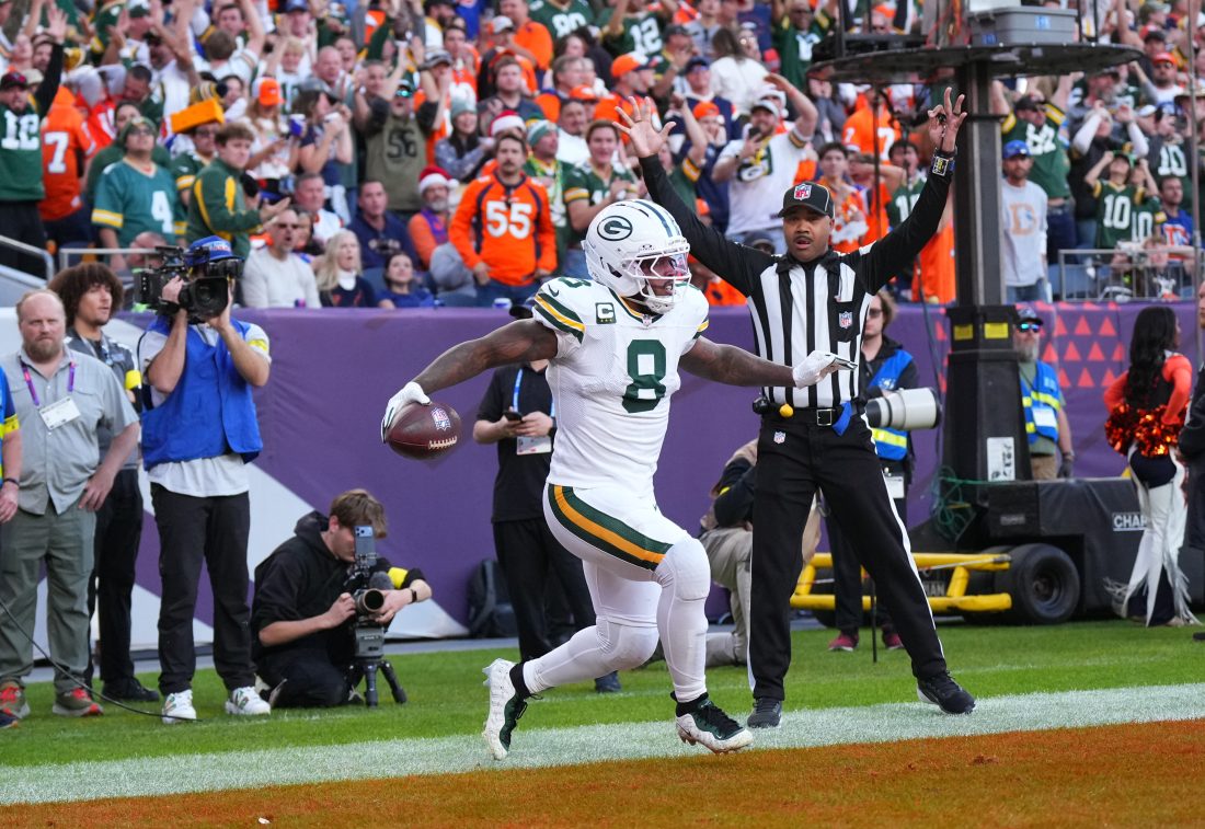 Dec 14, 2025; Denver, Colorado, USA; Green Bay Packers running back Josh Jacobs (8) reacts after a touchdown during the second quarter against the Denver Broncos at Empower Field at Mile High. Mandatory Credit: Ron Chenoy-Imagn Images