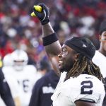 Dec 21, 2025; Houston, Texas, USA; Las Vegas Raiders running back Ashton Jeanty (2) holds a banana on the sideline after catching a touchdown pass against the Houston Texans during the third quarter at NRG Stadium. Mandatory Credit: Troy Taormina-Imagn Images