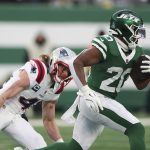Dec 28, 2025; East Rutherford, New Jersey, USA; New York Jets running back Breece Hall (20) runs for a touchdown against New England Patriots safety Brenden Schooler (41) during the second half of the game at MetLife Stadium. Mandatory Credit: