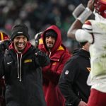 Jan 4, 2026; Philadelphia, Pennsylvania, USA; Washington Commanders quarterback Jayden Daniels (5) celebrates touchdown run by quarterback Josh Johnson (14) during the fourth quarter against the Philadelphia Eagles at Lincoln Financial Field. Mandatory Credit:
