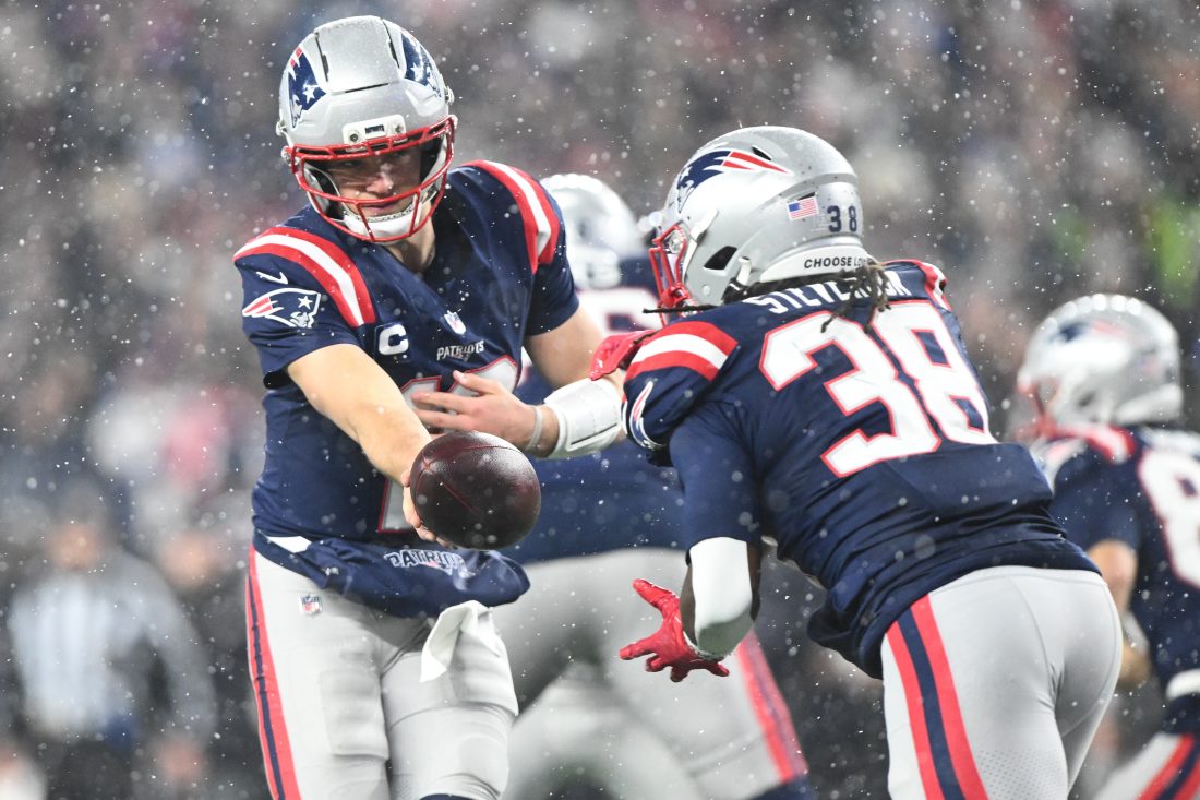 Jan 18, 2026; Foxborough, MA, USA; New England Patriots quarterback Drake Maye (10) hands off the ball in the third quarter against the Houston Texans in an AFC Divisional Round game at Gillette Stadium. Mandatory Credit: Brian Fluharty-Imagn Images
