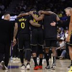 Jan 19, 2026; San Francisco, California, USA; Golden State Warriors forward Jimmy Butler III (10) is helped off the court after a knee injury during the third quarter against the Miami Heat at Chase Center. Mandatory Credit: Kelley L Cox-Imagn Images