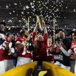 Jan 19, 2026; Miami Gardens, FL, USA; Indiana Hoosiers head coach Curt Cignetti hoists the trophy as he celebrates with defensive lineman Tyrique Tucker (95), wide receiver Elijah Sarratt (13), quarterback Fernando Mendoza (16), defensive lineman Mikail Kamara and defensive back D'Angelo Ponds (5) after defeating the Miami Hurricanes in the College Football Playoff National Championship game at Hard Rock Stadium.